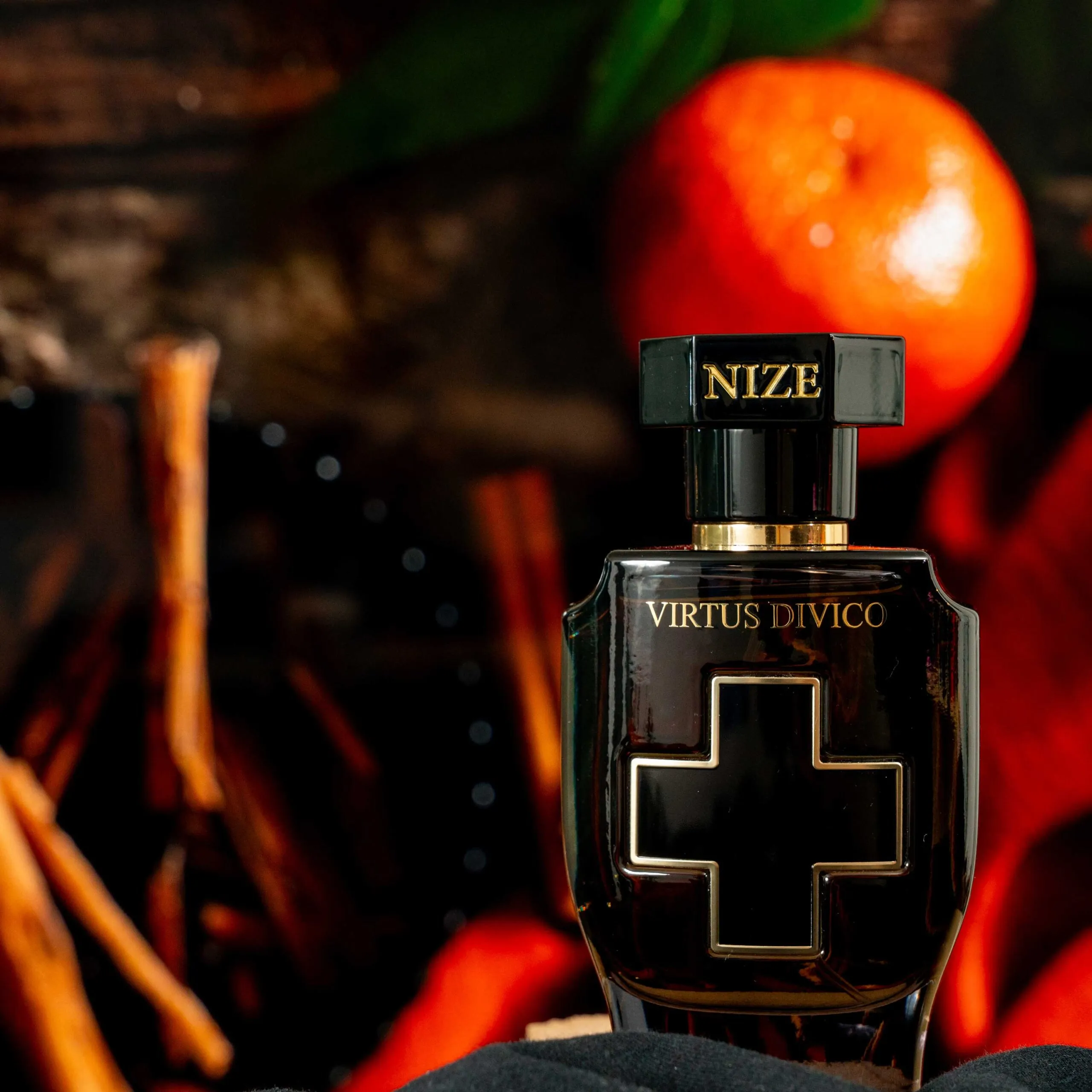 black luxury perfume bottle standing in front of an orange